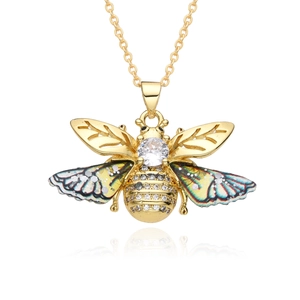 Golden bee necklace with crystal center and colorful enamel wings on white background