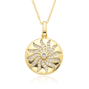 Macro detail of gold clock pendant with micro-pave zircons and sunburst design