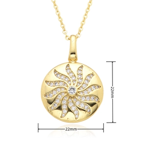 Macro detail of 22mm sunburst clock pendant with micro-pave zircons and golden plating