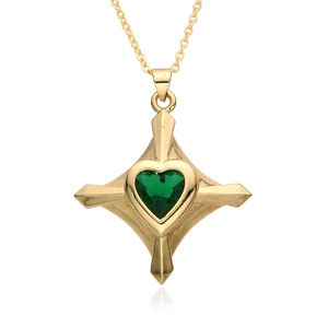 Macro detail of gold-plated star pendant with green heart zircon center and polished finish