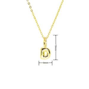 Macro view of gold bubble letter D pendant with cubic zirconia stones on thin chain