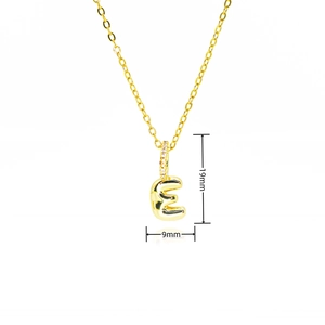 Detail showing gold bubble letter E pendant dimensions of 19mm by 9mm with zircon
