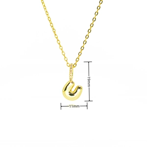 Macro shot of gold letter U balloon pendant with cubic zirconia bail and size dimensions