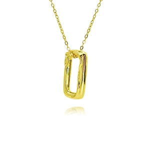 Macro detail of a square gold sun pendant with textured surface on a gold chain necklace