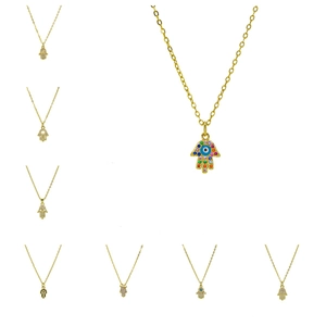 Detailed macro view of gold-plated Hamsa Hand pendant with blue Evil Eye and zircon stones