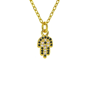 Macro shot of gold Hamsa Hand pendant with black and white zircon stone inlay