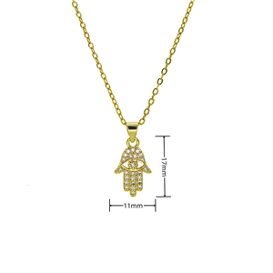 Detailed view of gold Hamsa hand necklace pendant with blue eye and pavé zircon stones