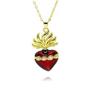 Detail showing vintage gold-plated sacred heart pendant with red enamel and crystals