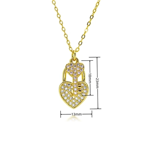Macro shot of gold-plated heart lock and key pendant with size dimensions in millimeters