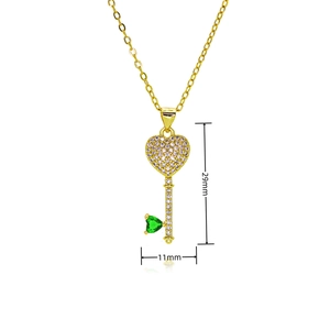Detailed view of gold plated heart key pendant with dimensions 29mm by 11mm