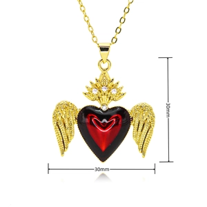 Macro detail of winged heart pendant with red enamel and dimensions 30mm x 30mm