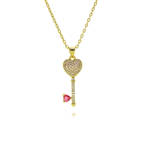 Detail showing gold key pendant with heart-shaped white zircons and pink gemstone