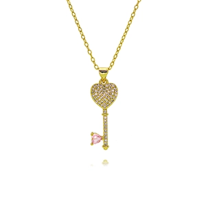 Detail of gold heart-key pendant with micro-pave white zircons and pink heart gemstone