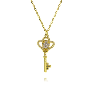 Macro shot of gold-plated key pendant necklace with sparkling crown and zircon details