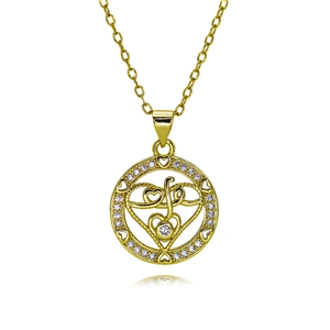 Detailed macro view of heart-shaped gold necklace pendant with sparkling zircon inlays