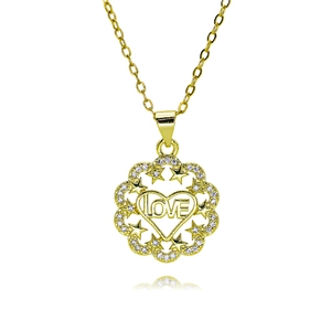 Detailed macro view of gold heart pendant necklace with LOVE engraving and zircons
