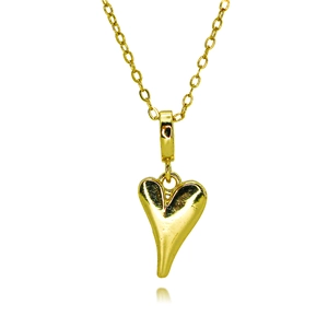 Macro shot of an elegant gold heart-shaped pendant with a modern asymmetric design