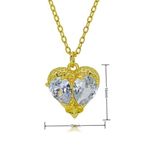 Detailed macro view of 15mm gold heart pendant necklace with shimmering zircon stones