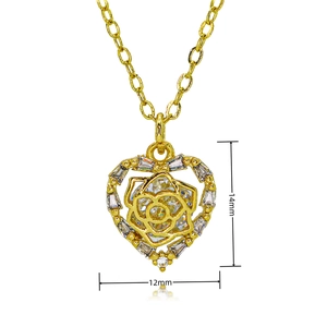 Detailed view of heart-shaped gold pendant with rose center and zircon inlays