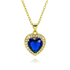 Macro shot of heart-shaped blue zircon pendant necklace with pavé diamond halo in gold