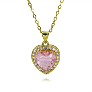 Macro shot of gold heart necklace featuring a large pink zircon center and halo diamonds