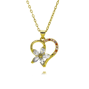 Detailed macro of gold heart necklace with zircon floral pattern and pink crystals