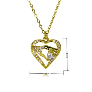 Detail view of a gold heart pendant with zircon pavé border and 18mm size specs