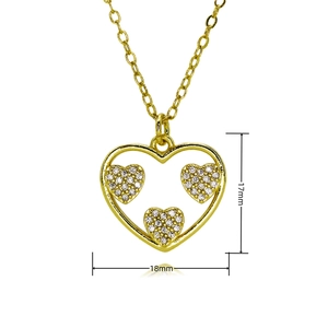 Macro detail of gold heart pendant with zircon inlay and dimensions of 17mm by 18mm