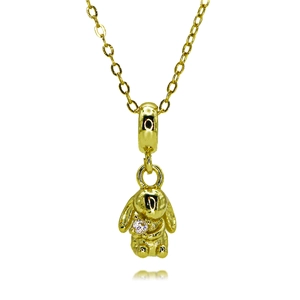 Detail of a golden rabbit pendant with a sparkling zircon on a delicate O-chain