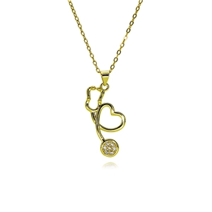 Macro shot of gold-plated stethoscope pendant featuring a sparkling crystal heart