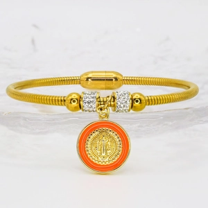 Detail of gold snake chain bracelet with orange enamel San Benito charm and magnetic clasp