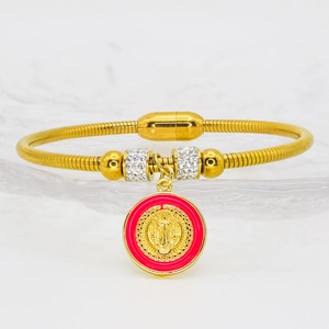 Detail of gold magnetic bangle with red religious medal and rhinestone cylinder charms