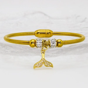 Detail of gold dolphin tail bracelet with sparkling crystals and magnetic clasp closure