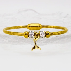 Golden snake chain bracelet with crystal dolphin tail charm and magnetic clasp closure