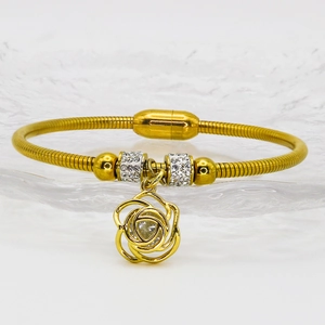 Detail of rose gold snake chain bracelet with sparkling crystal rose pendant and magnetic clasp