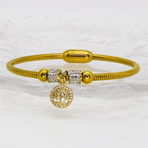 Detailed macro view of gold snake chain bracelet with magnetic clasp and tree of life charm