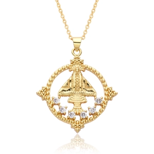 Close-up of gold religious icon pendant with white zircon stones and round bead frame