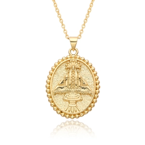 Detail of 18k gold plated religious pendant with intricate relief and beaded edge