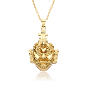 Macro shot of 18k gold plated religious deity pendant with intricate carved details