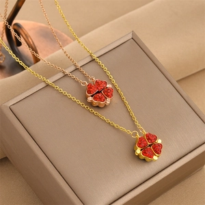 Macro detail of foldable magnetic four-leaf clover pendant with red zircon inlay