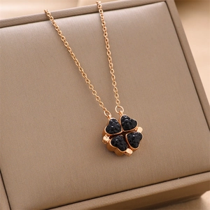 Rose gold clover necklace with black crystals and magnetic folding design on jewelry box