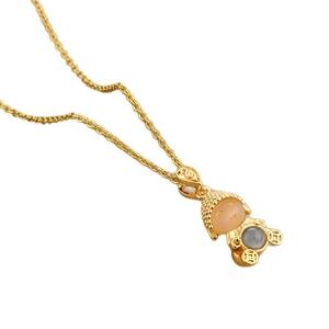 Gold Buddha necklace with pink jade head and ancient coin pattern on a white background
