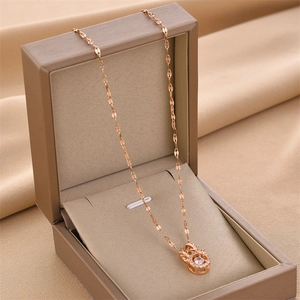 Elegant rose gold stag antler necklace with a sparkling round zircon in a jewelry box