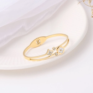 Elegant gold titanium steel cuff bracelet featuring shell flower and star clover patterns