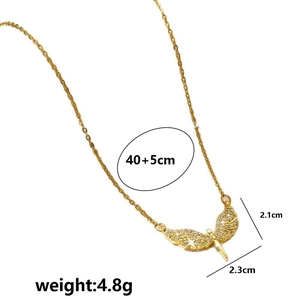 Golden dragonfly wing pendant necklace with zircons and measurements on white background