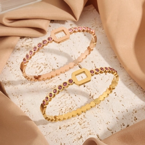 Titanium steel honeycomb bangle with diamonds in gold and rose gold on satin
