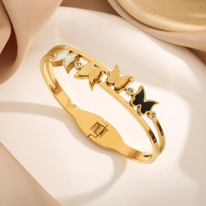 Elegant gold butterfly bangle for women featuring mother of pearl and black accents
