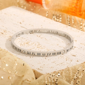 Silver stainless steel roman numeral bangle with diamonds on white marble stone