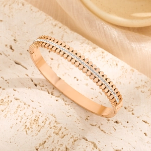 Rose gold double row petal bangle with cubic zirconia on beige stone base