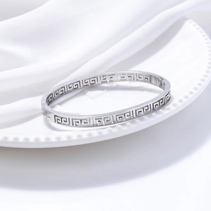 Silver Great Wall pattern titanium steel cuff bracelet with vintage hollow design on porcelain